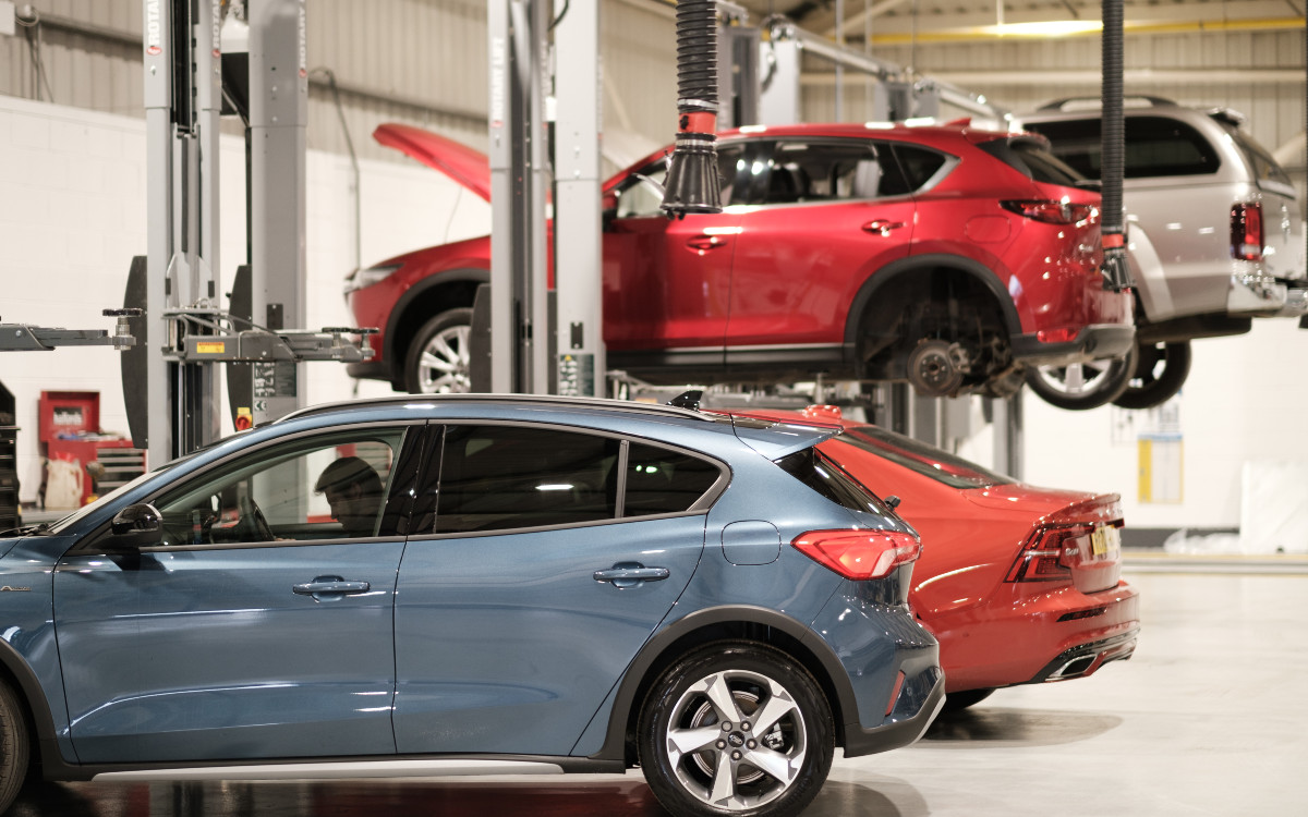 Cars lined up in a car service workshop; manufacturer servicing