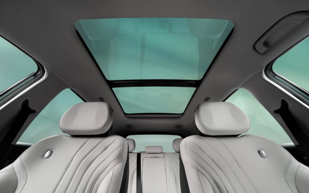 Geely EX5 interior with panoramic sunroof and light seats.