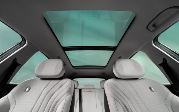Geely EX5 interior with panoramic sunroof and light seats.