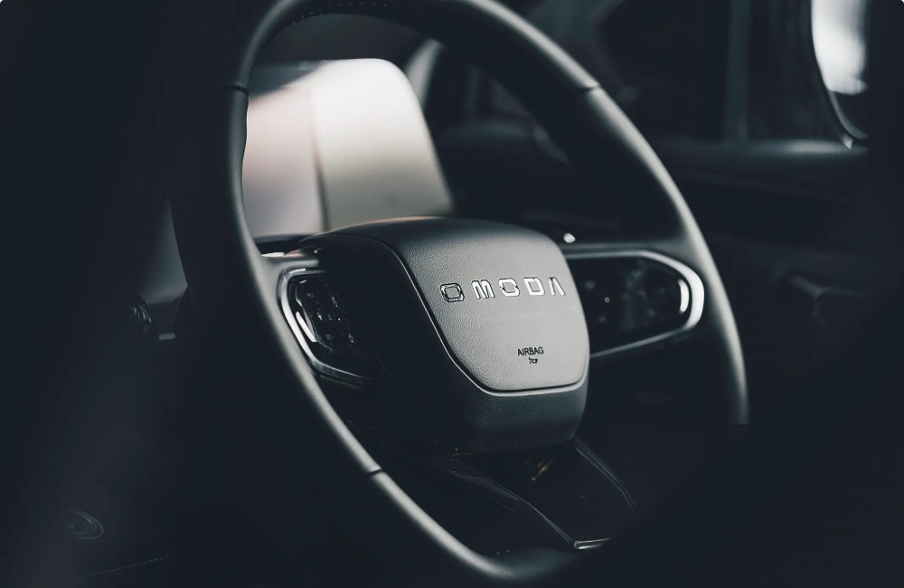 Close-up shot of an OMODA branded steering wheel.