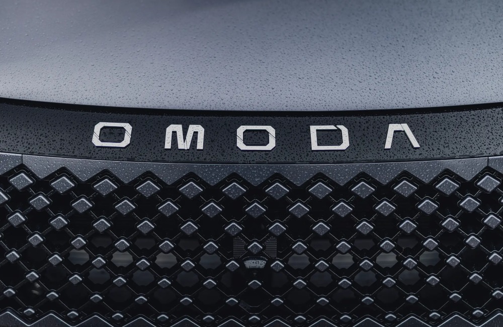 The front of an OMODA vehicle, showing off a unique grille design and OMODA branding