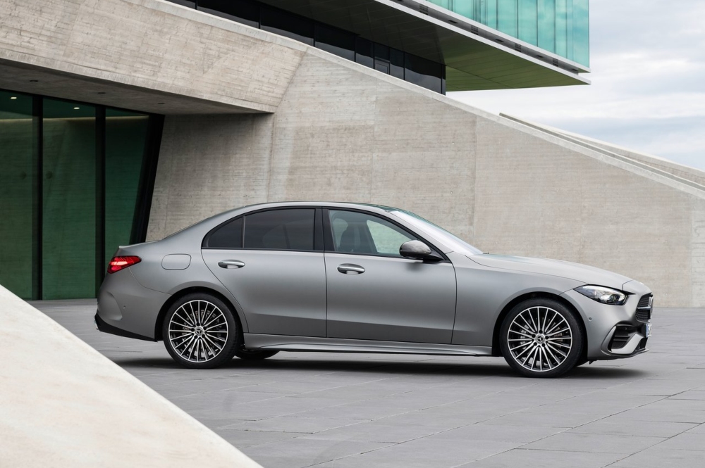 Used Mercedes C-Class for sale, parked outside an office building.