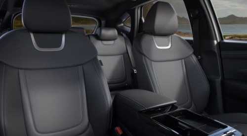 Interior shot of the new Hyundai TUCSON Hybrid, showing the centre console and comfortable front seating.