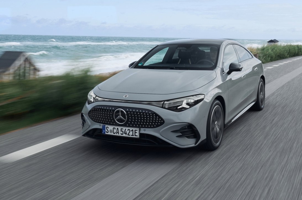 Used Mercedes CLA for sale, driving along a coastal road.