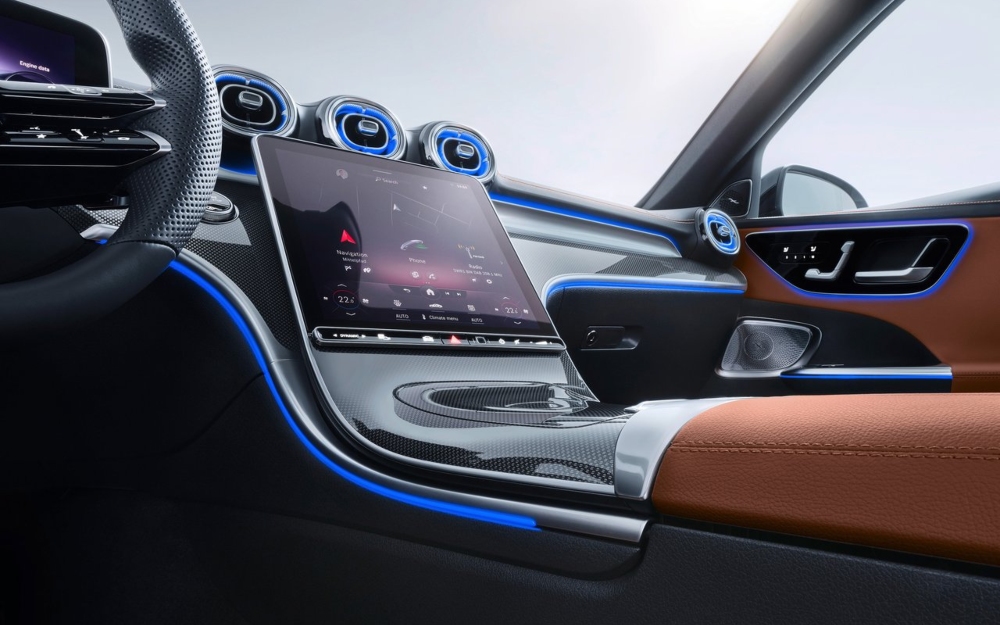 Used Mercedes-Benz C-Class interior with steering wheel and centre touchscreen.