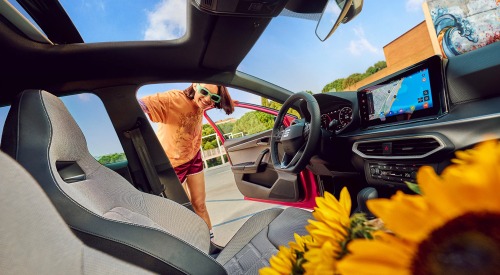 Interior shot of someone looking into a new SEAT Ibiza interior with a happy smile.