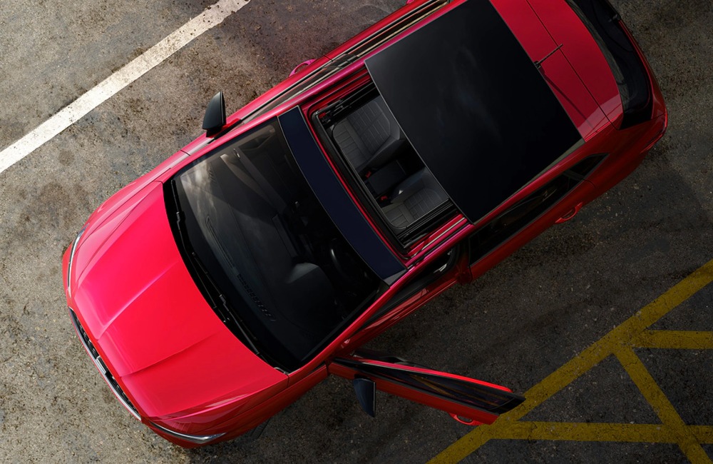 Top down view of a new SEAT Ibiza, showing off the sunroof and vibrant red colour.