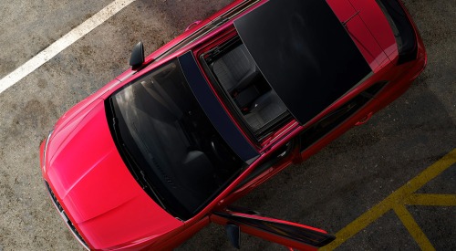 Top down view of a new SEAT Ibiza, showing off the sunroof and vibrant red colour.