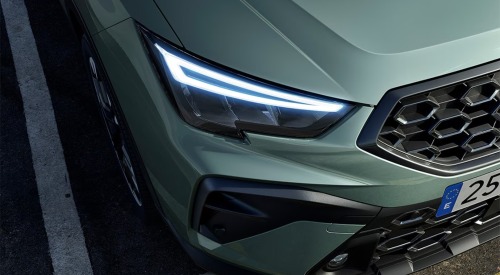 Close up angled front shot of a new SEAT Arona and its LED lighting.