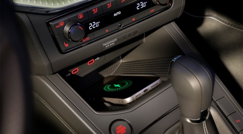 Close up shot of the centre console with a phone charging within a new SEAT Arona.