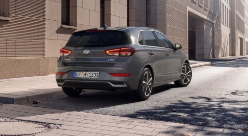 Rear view of a new Hyundai i30 car, parked on a city street.