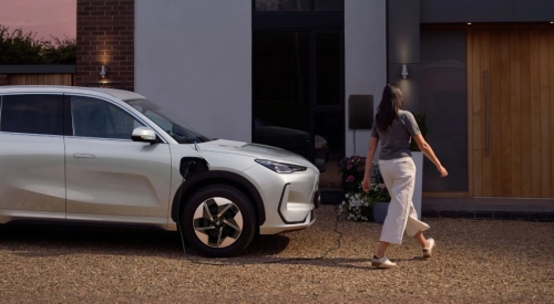 A person charging the Geely EX5 at home; Second-hand Geely EX5 for sale