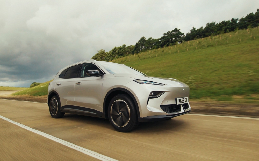 MGS5 EV in Cosmic Silver driving along a road with a grassy verge.