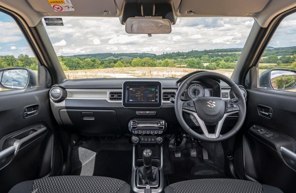 Interior shot of a Suzuki Ignis, showing off the infotainment system and drivers position.