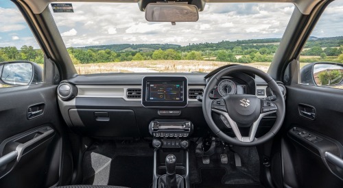 Interior shot of a Suzuki Ignis, showing off the infotainment system and drivers position.