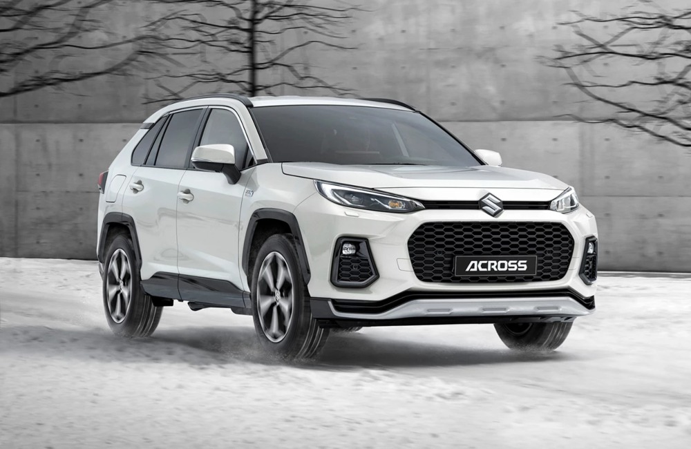 Front shot of a new Suzuki Across driving through snow at speed.