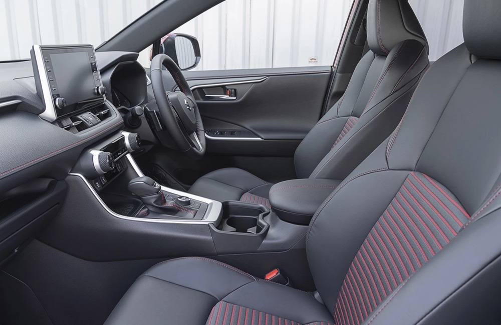 Interior of a new Suzuki Across showing off the comfortable front seats and advanced infotainment system.