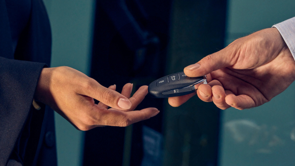 Person exchanging keys after buying a Peugeot car