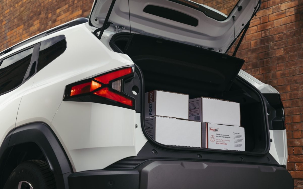 White Dacia Duster Cargo Hybrid rear three quarter view.