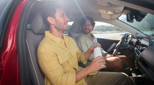 Two people sat in the front two seats of a new Citroen C4.