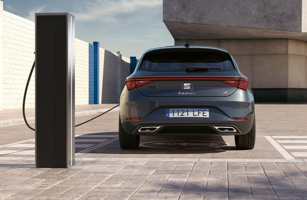 Rear shot of a SEAT Leon e-Hybrid charging up at a charging station.