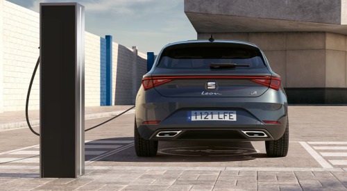 Rear shot of a SEAT Leon e-Hybrid charging up at a charging station.