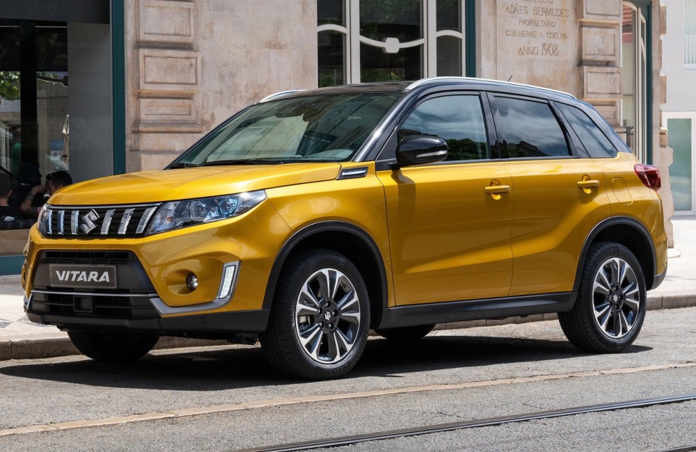 Angled side view of a used Suzuki Vitara parked on a city road.