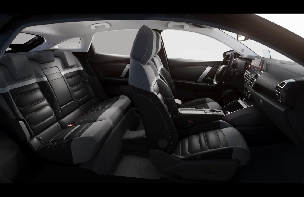 Interior side shot of a Citroen C4 showing off the comfortable seating, driving position, and stylish design.