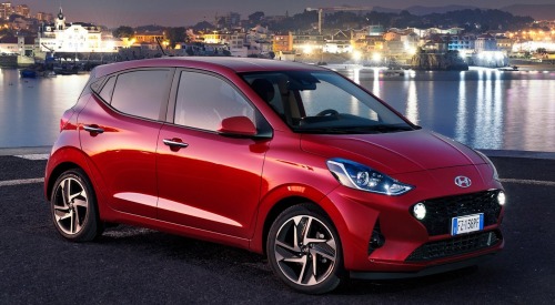 Angled side view of a used Hyundai i10, showing off the LED lighting, ally wheels, and unique design.