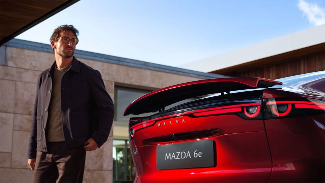 New Mazda car with man next to it