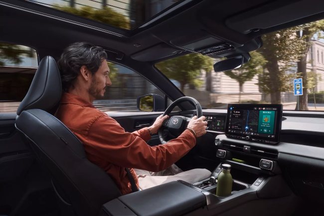 Man Driving New Toyota RAV4 with all the tech