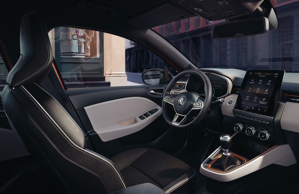 Interior of a used Renault Clio, showing off the infotainment system, steering wheel, and driver position.