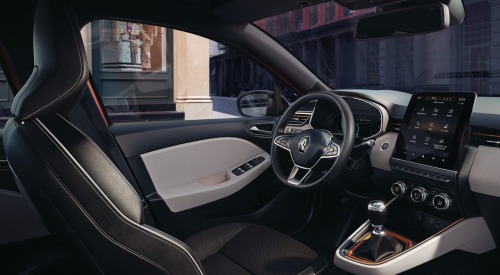Interior of a used Renault Clio, showing off the infotainment system, steering wheel, and driver position.