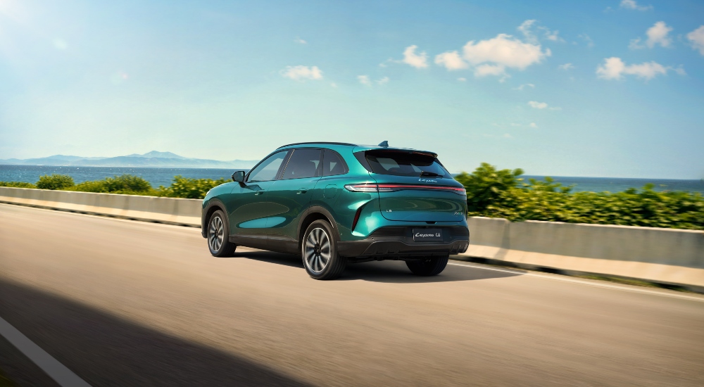 Rear view of a Expressive Emerald LEAPS as drives along a road; New LEPAS Warranty