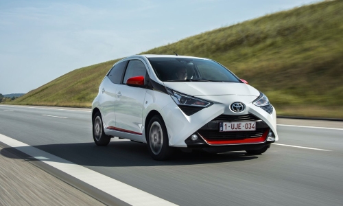 Used Toyota Aygo driving down road