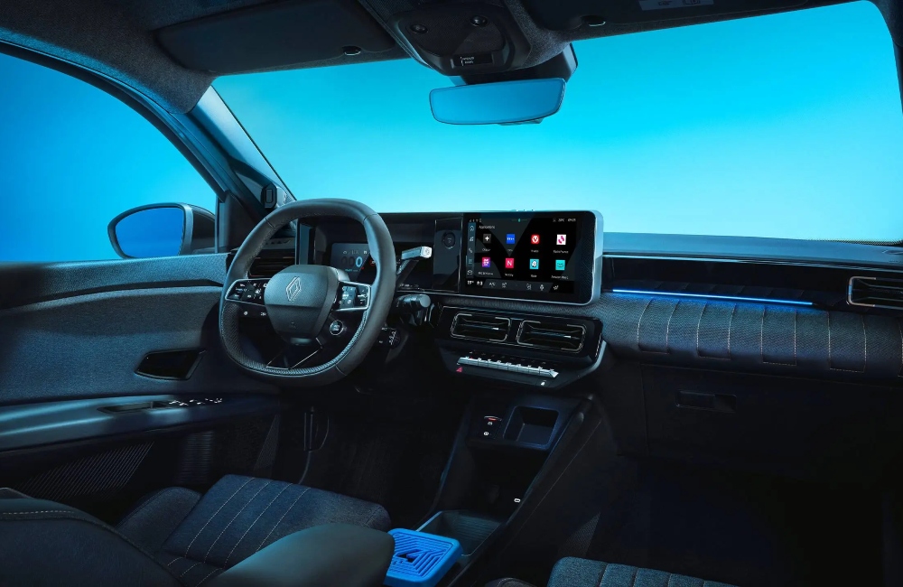 Interior shot of a new Renault 4 Plein Sud, showing off the driving position and infotainment system.