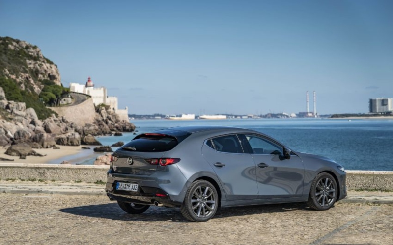 grey used mazda3 sat overlooking the sea