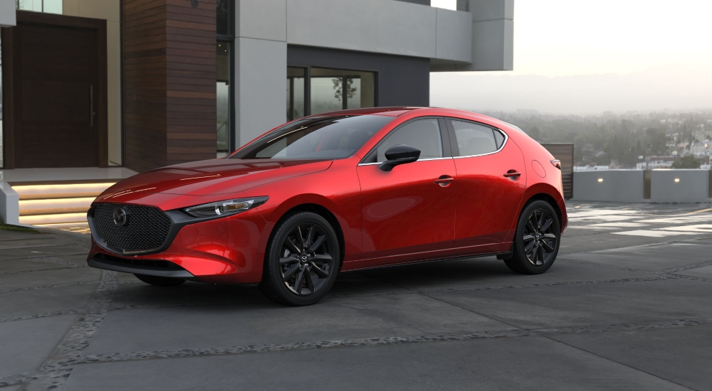 Red Mazda3 parked outside