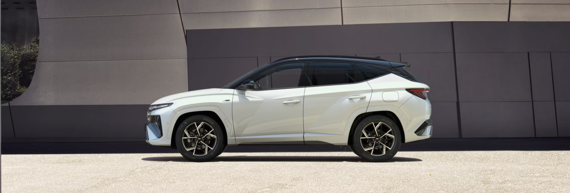 Side profile of a white new Hyundai TUCSON.