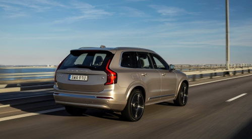 A Volvo XC90 Plug-in Hybrid driving down a road rear view; Used Volvo XC90 Plug-in Hybrid finance deals