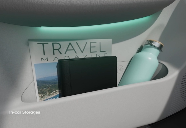 Close up shot of a storage compartment filled with a water bottle, magazine, and book.