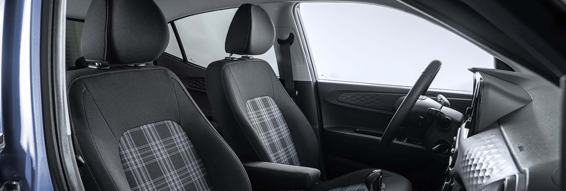 Interior shot of a new Hyundai i10, showing off the comfortable seating and the stylish design.