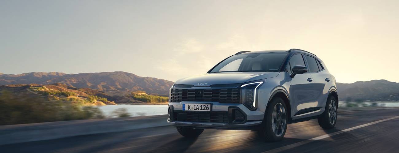 The New Kia Sportage driving down a road - The New Kia Sportage for sale