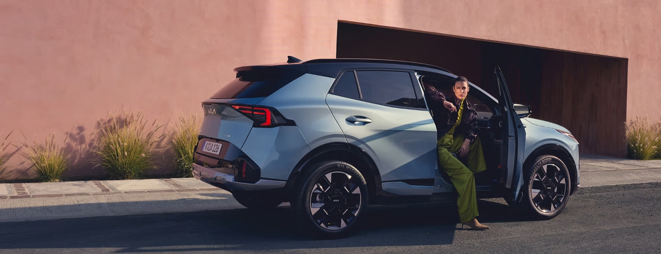Person leaving The New Kia Sportage Hybrid; New Kia Sportage Hybrid cars for sale