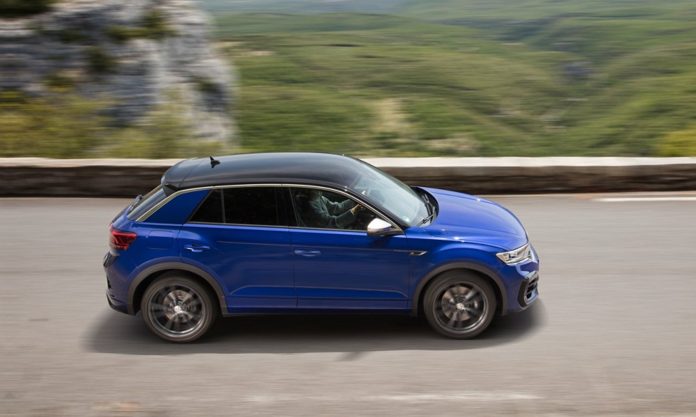 Blue used VW SUV driving down a country road at speed.