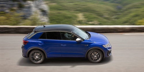 Blue used VW SUV driving down a country road at speed.