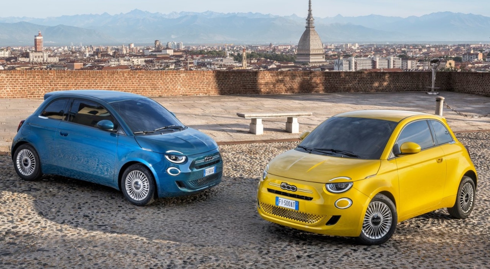 The New Fiat 500 Hybrid in blue and yellow parked on cobbles; New Fiat 500 Hybrid models