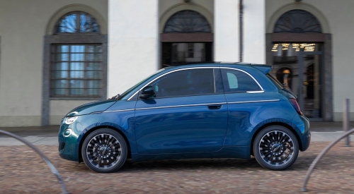 A blue Fiat 500 Hybrid driving a long a cobbled street; New Fiat 500 Hybrid Finance Deals