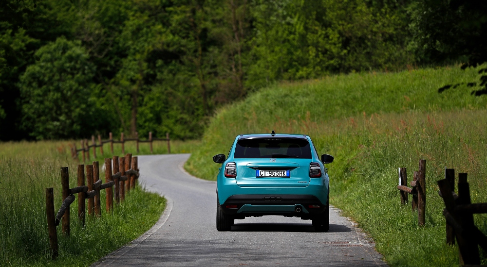 The rear view of a Fiat 600 Hybrid drivng down a road; New Fiat 600 Hybrid finance deals