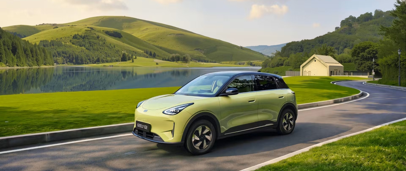 A Geely EX2 in Aurora Green driving along a road; New Geely EX2 Car for Sale